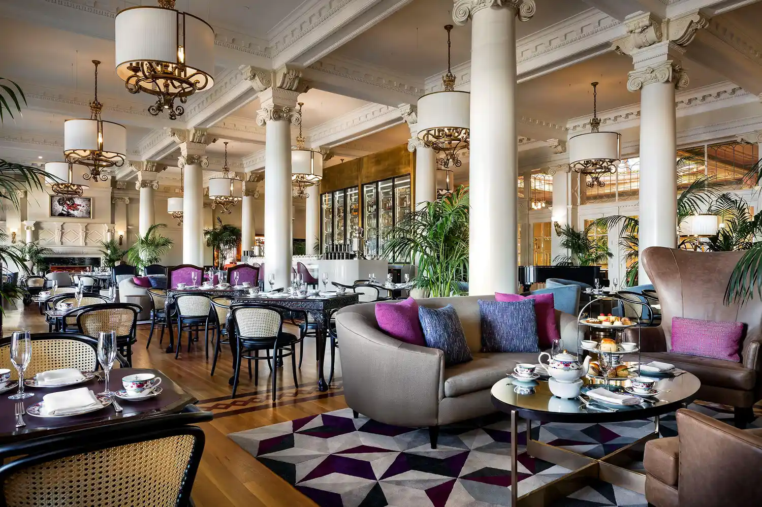 Interior of the elegant Lobby Lounge at the Fairmont Empress featuring high ceilings and luxury furnishings.