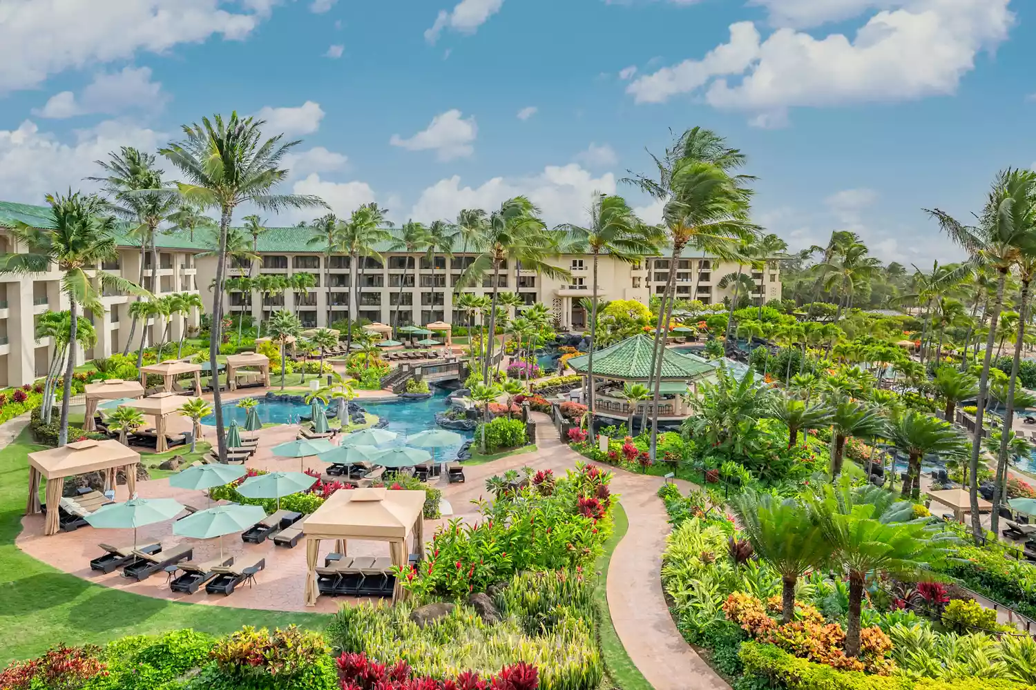 Aerial view of the Grand Hyatt Kauai featuring its massive multi-level pool system and saltwater lagoon.