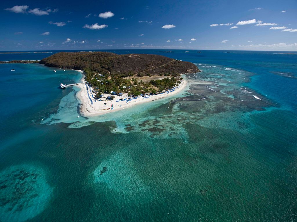 Aerial view of El Conquistador Resort perched on a 300-foot cliff overlooking the Caribbean Sea.