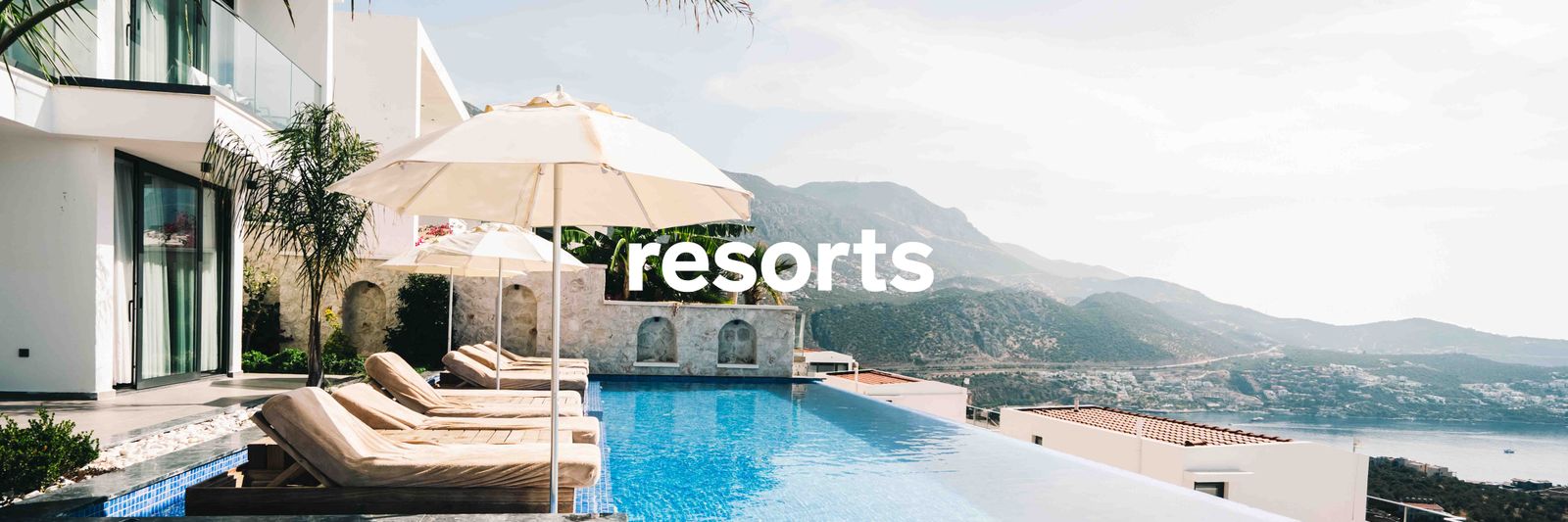 Aerial view of a luxury resort with a pristine swimming pool and modern architecture.