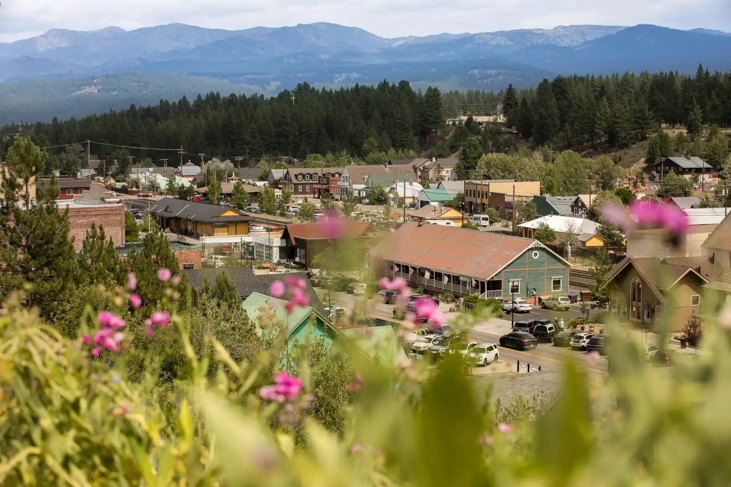 A view of downtown Truckee, California, nestled amidst dense forests and mountain peaks.