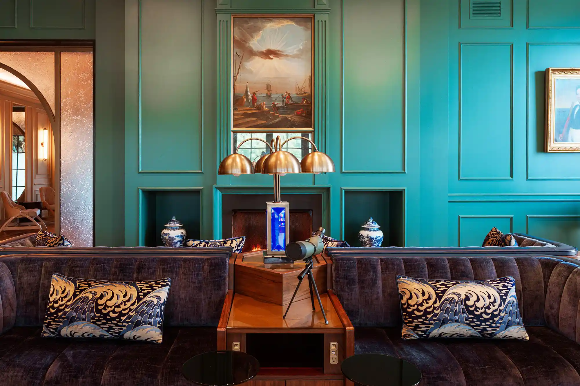 A richly decorated boutique hotel lounge featuring a telescope and velvet upholstery.