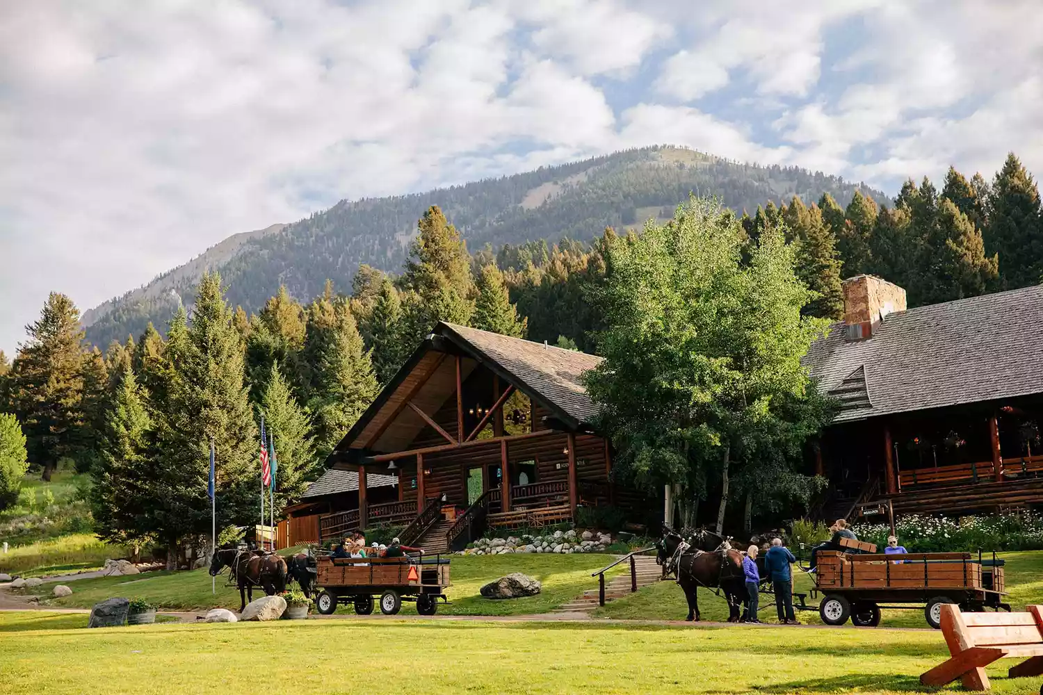 A charming log cabin exterior at Lone Mountain Ranch during the day.
