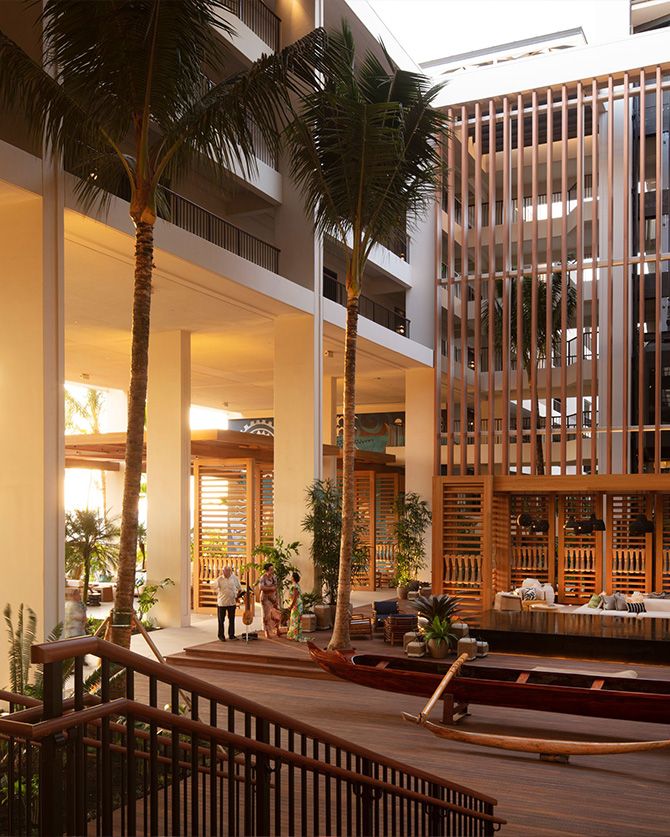 The elegant and modern indoor-outdoor lobby showing the high-end hardwood finishes and open-air design.