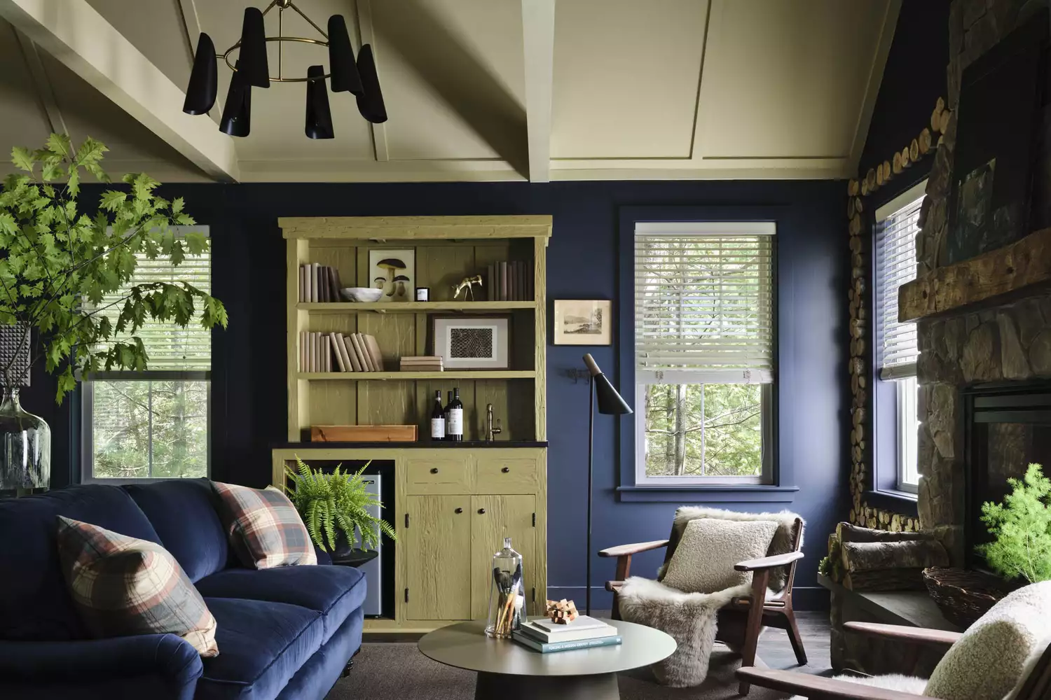Mountainside cabin interior living room with wood paneling and luxury furnishings.