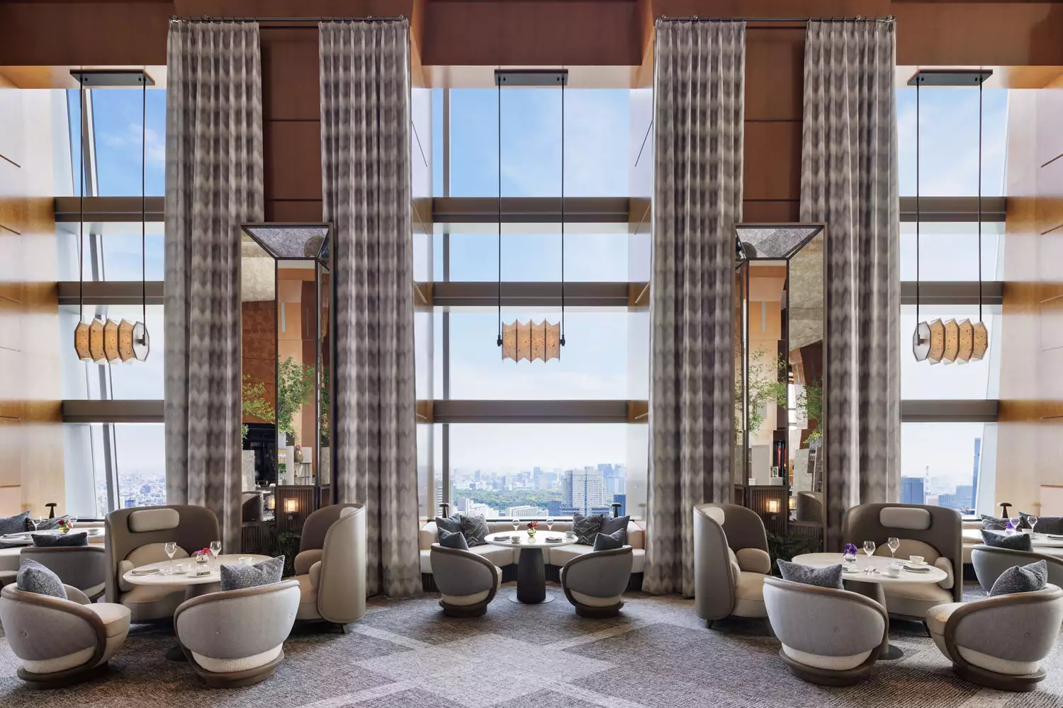 High-altitude restaurant seating looking out over the Tokyo skyline at The Ritz-Carlton.