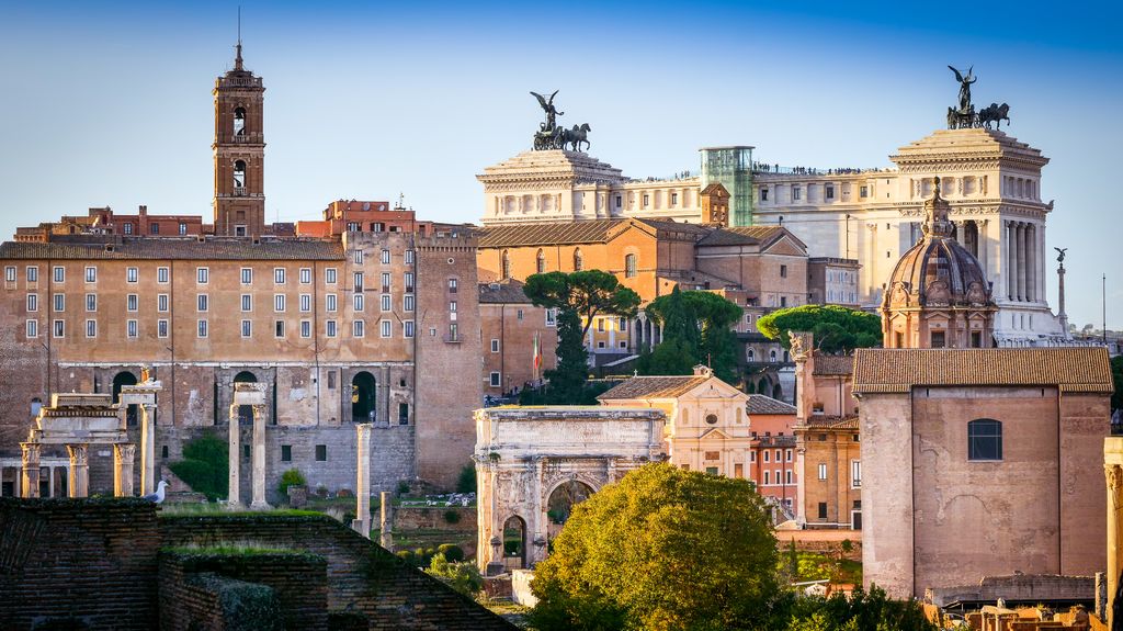 Ancient ruins, columns, and arches of the Roman Forum and Palatine Hill.