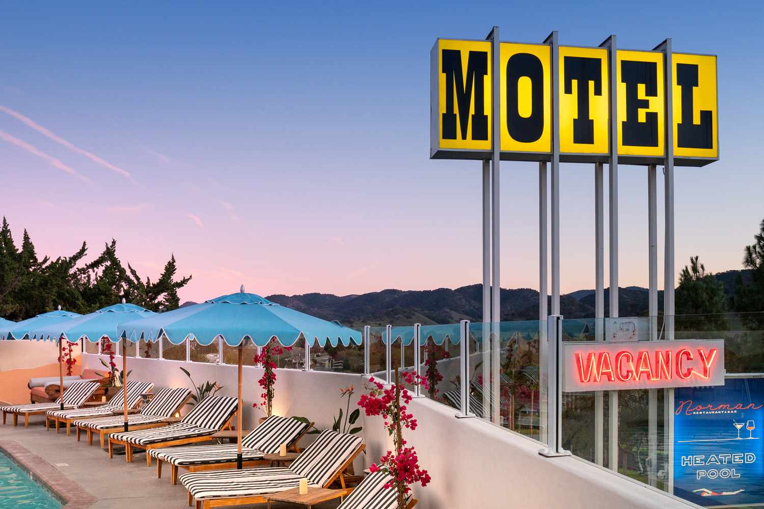 Panoramic view of a stylishly renovated California motor lodge courtyard.