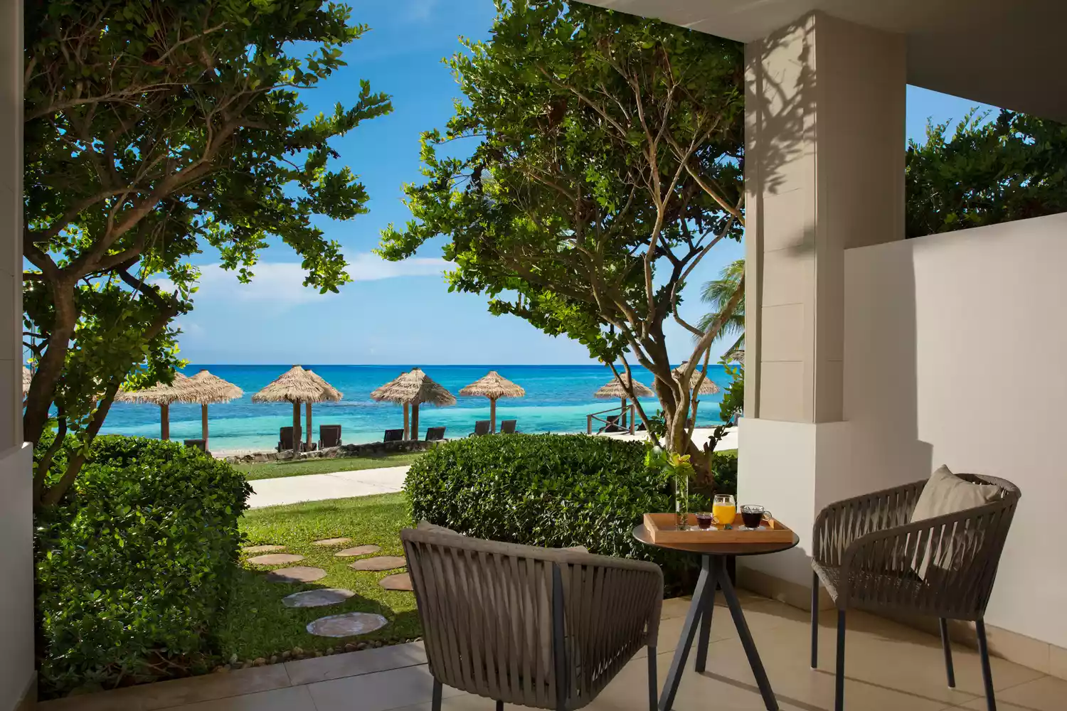 A resort patio at Secrets Wild Orchid in Montego Bay with a view of the Caribbean Sea.