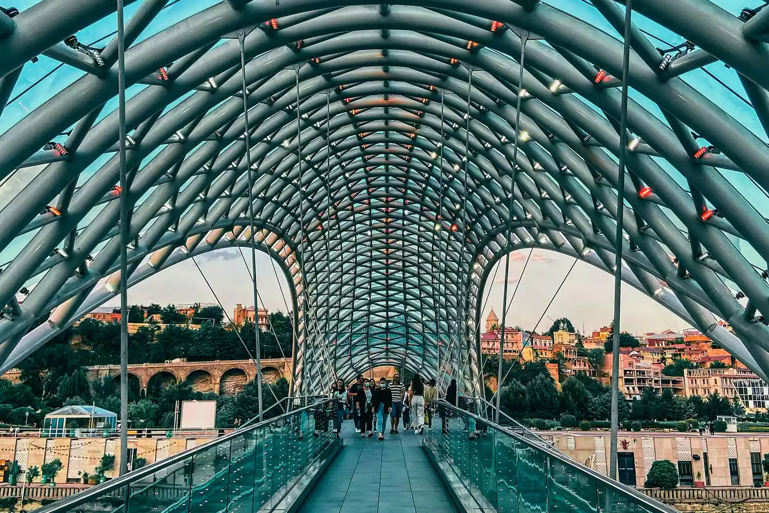The contemporary glass and steel Bridge of Peace spanning the Mtkvari River in Tbilisi.