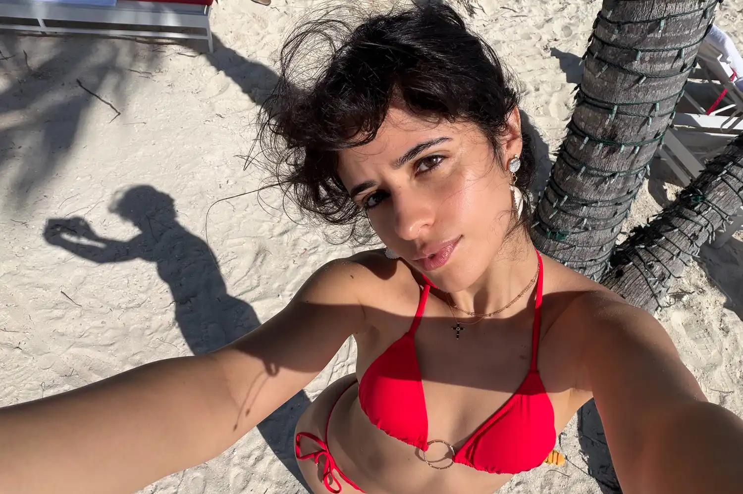 Camila Cabello enjoying a personal travel moment on a beach.