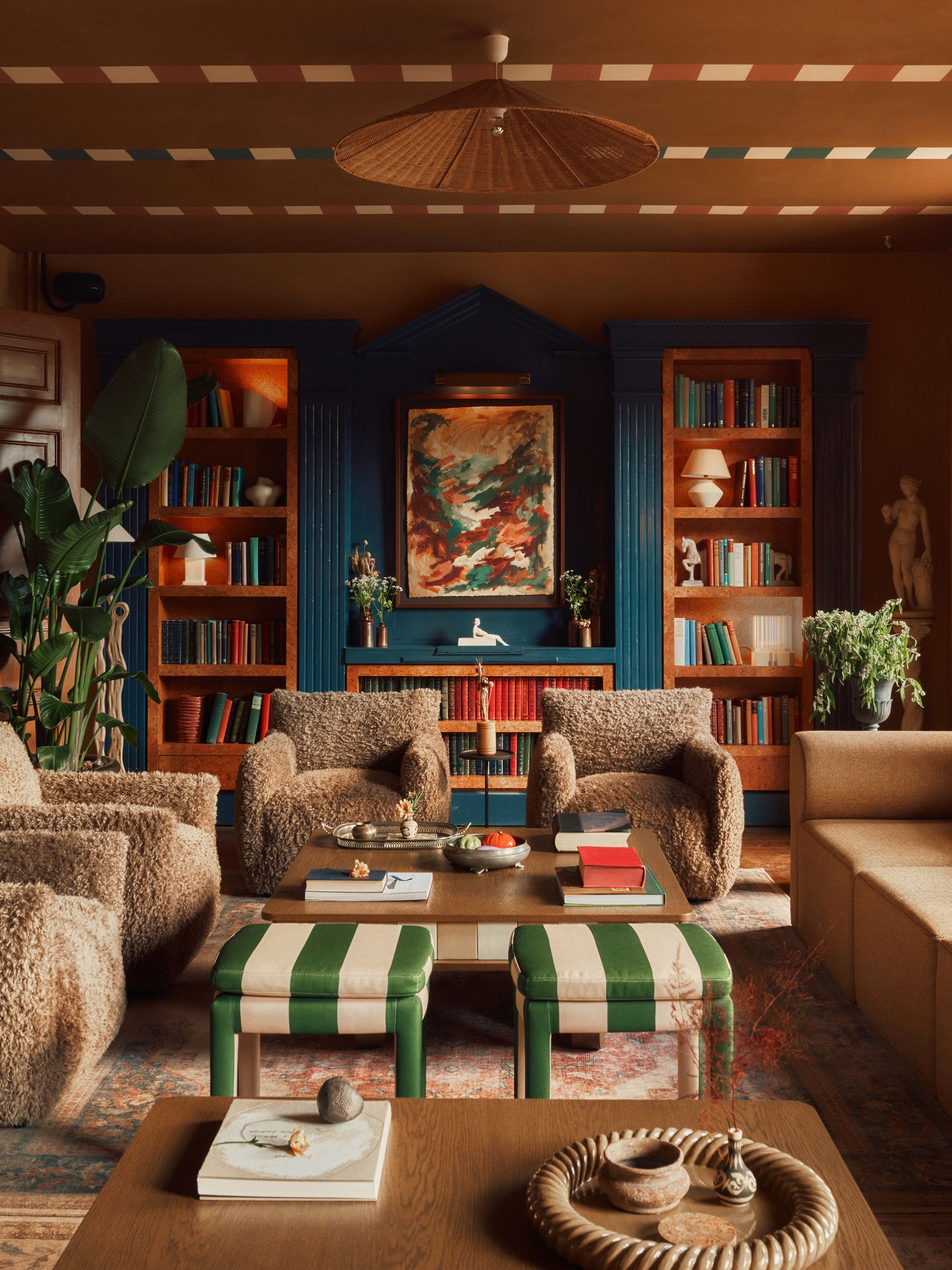 A person relaxing in a lounge area surrounded by bespoke timber furniture and natural light.