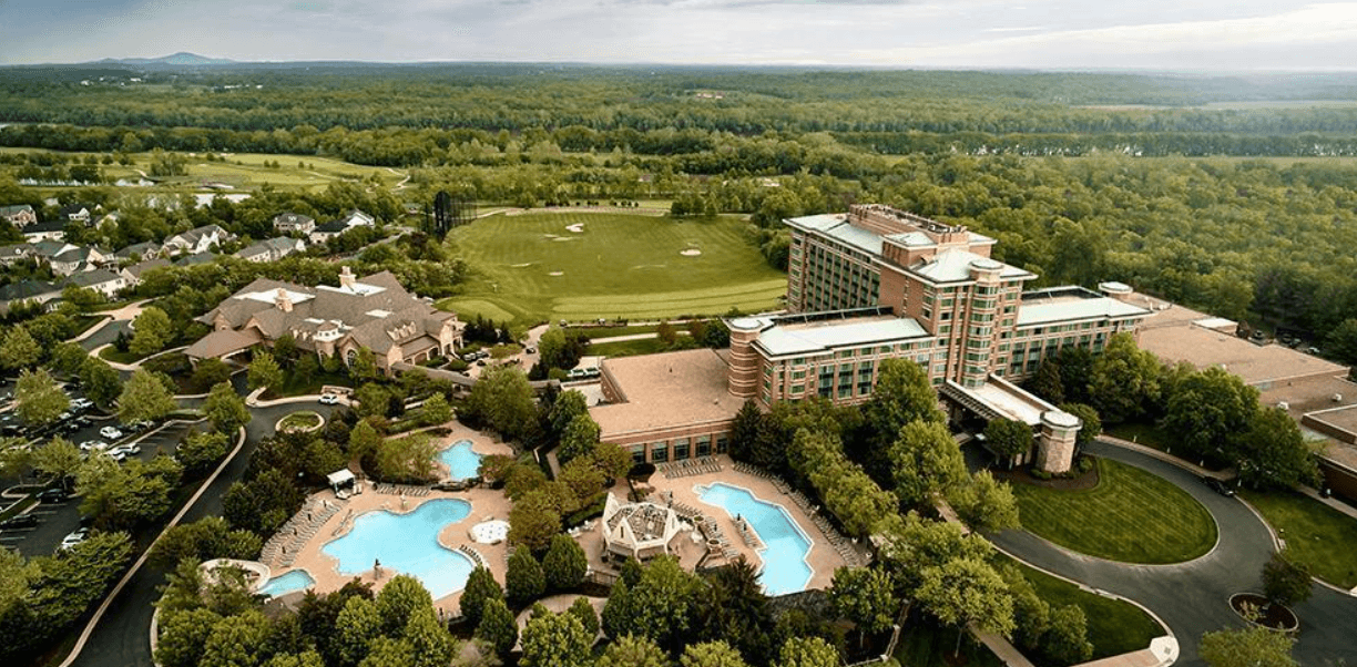 Aerial view of the resort's expansive outdoor pool complex and architectural layout.