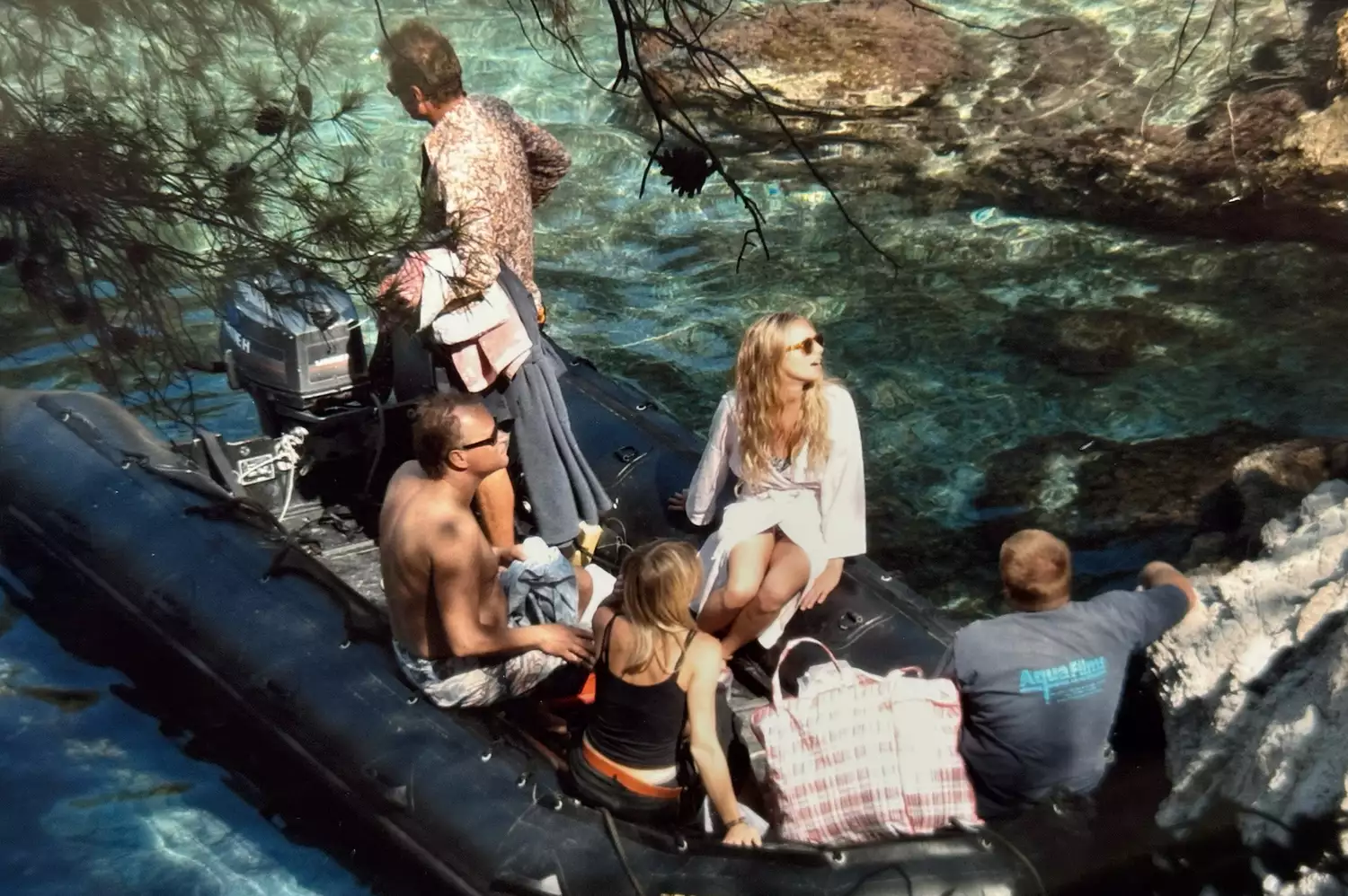 A group including Amanda Seyfried enjoying a boat ride on clear blue water in Greece.
